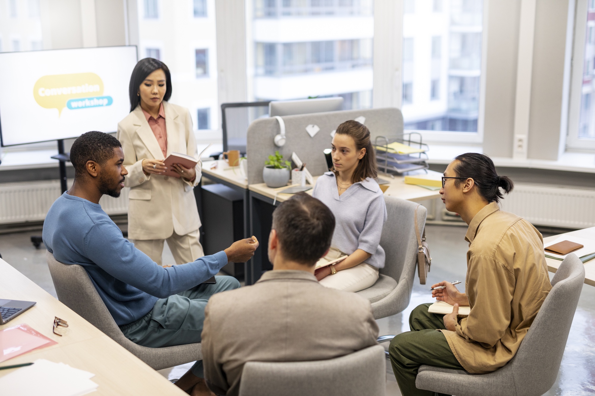 Session de formation en équipe avec plusieurs collaborateurs échangeant autour d'une table
